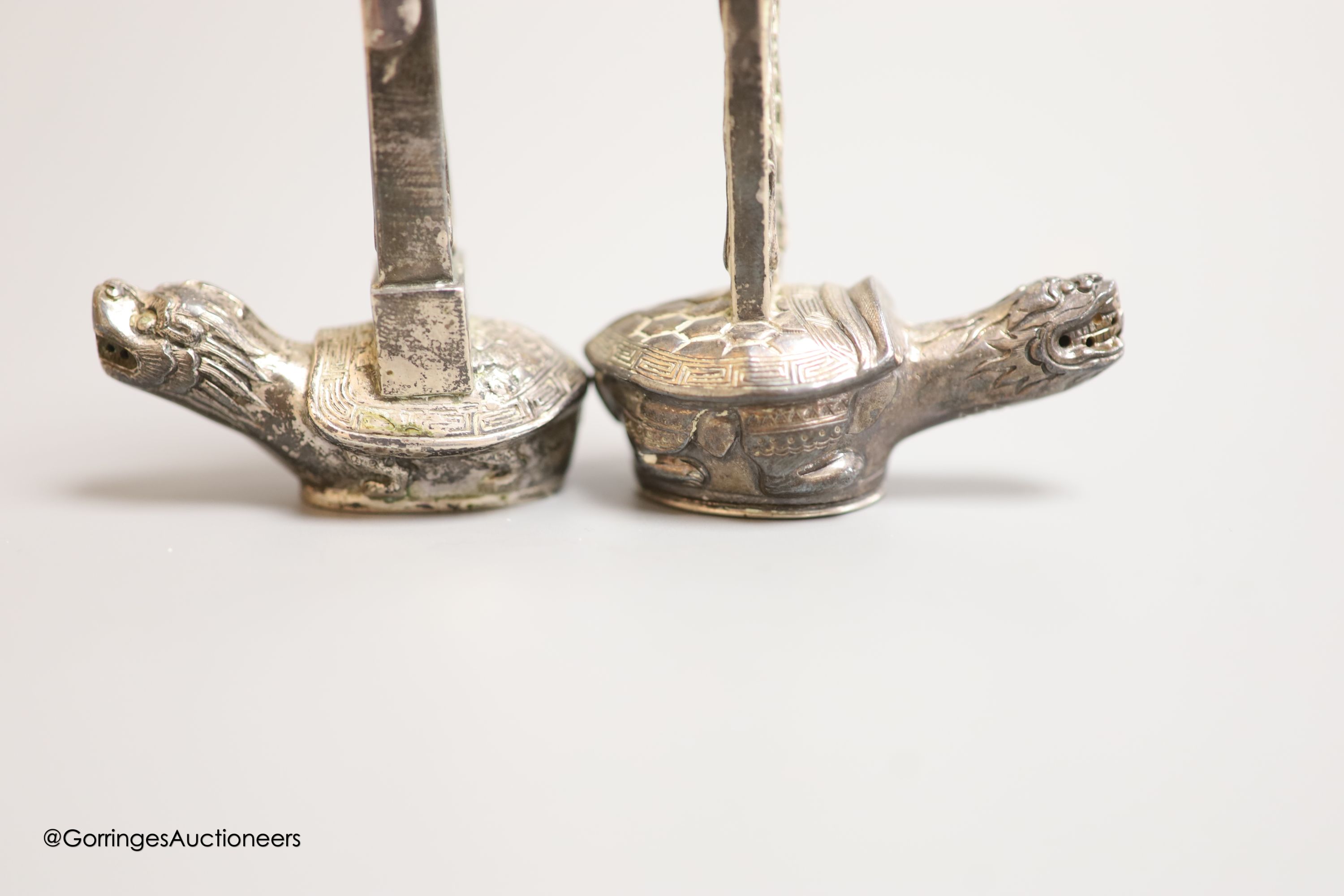 Two Chinese white metal salt and pepper shakers, 9cm and a Canton enamel cup.